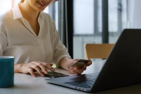 Enjoy wonan's hands typing mobile keyboard and holding credit card online Stock Photos