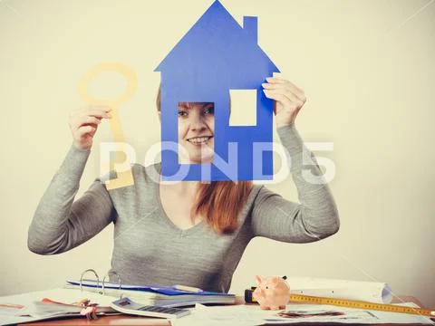 Enjoyable estate agent with house ang key. Stock Photos