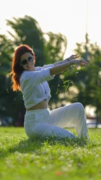 The enjoyable time a young red-haired woman spends in the park Stock Photos