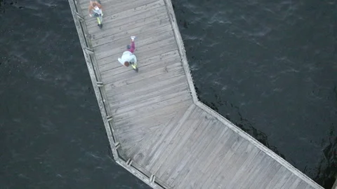 Enjoying the beautiful sea boardwalk while riding an electric scooter Stock Footage 319919759