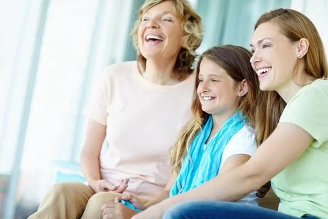 Enjoying a bit of television. Three generations of family girls sitting together 스톡 사진