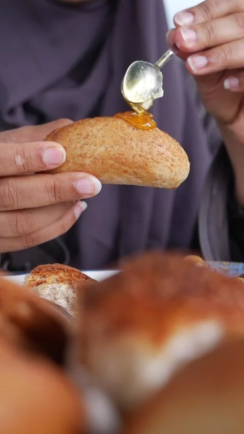 Enjoying breakfast with honey and bread in a local cafe Stock Footage 336355256