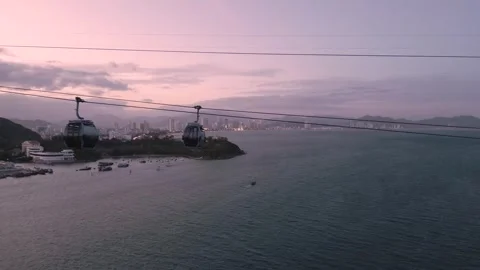 Enjoying breathtaking views from a cable car over coastal waters at sunset Stock Footage 308247079