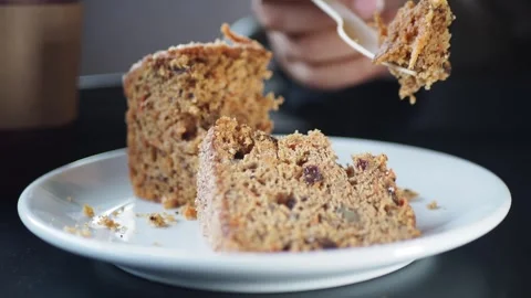 Enjoying a cake slice at a cafe table Stock Footage 336882560