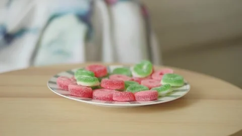 Enjoying candy on a wooden table Stock Footage 337810347