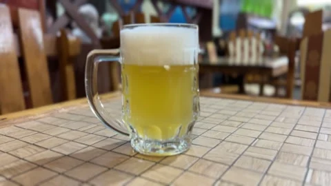 Enjoying Chilled Beer in a Charming Rustic Setting Surrounded by Bubbles and Stock Footage 316478178
