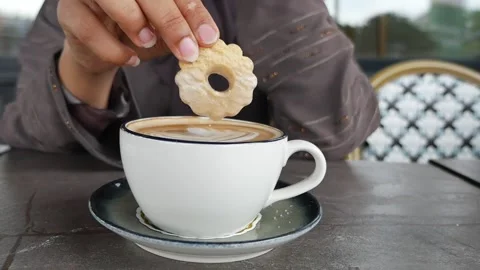 Enjoying coffee and cookie at a café in a city Stock Footage 340443019