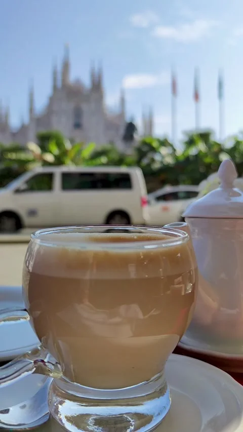 Enjoying Coffee at a Cafe With a View of the Landmark Cathedral in the Stock Footage 314393196