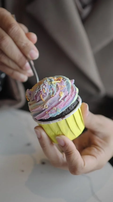 Enjoying a colorful cupcake in a cafe Stock Footage 340178554