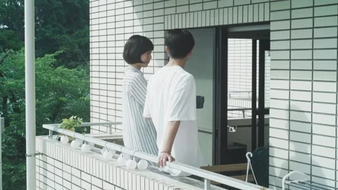 Enjoying Conversation Over Coffee on the Balcony Stock Footage 332859867