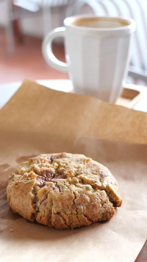 Enjoying a cookie and coffee at a local cafe Stock Footage 338216973