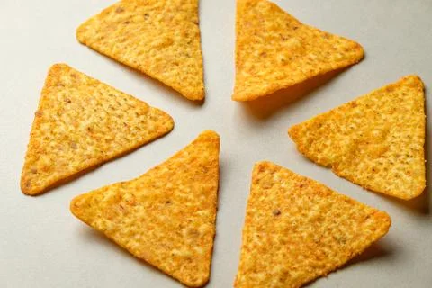 Enjoying crispy nacho chips during a festive gathering with friends Stock Photos