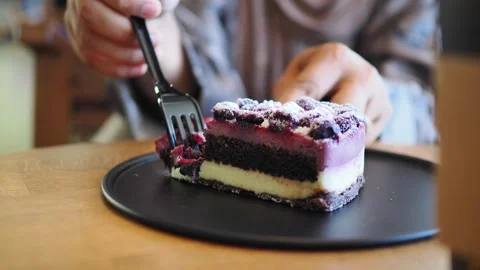 Enjoying dessert with a delicious cake slice Stock Footage 343048253