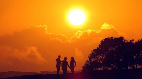 Enjoying dramatic sunset with friends Stock Photos