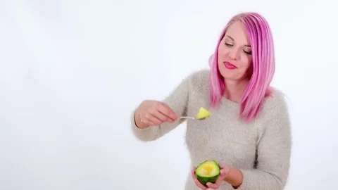 Enjoying eating an avocado Stock Footage 83724629