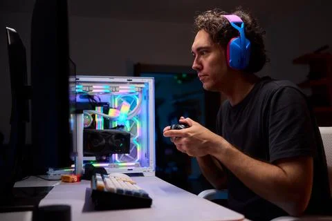 Enjoying an exciting gaming session with a controller and large screen for Foto stock