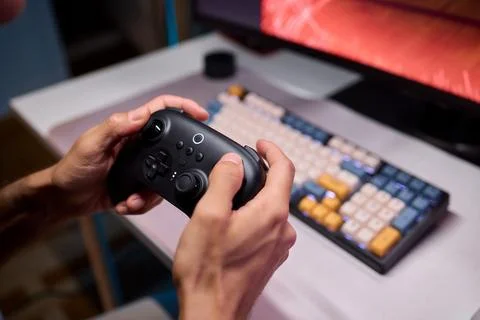 Enjoying an exciting gaming session with a controller and large screen for Foto stock