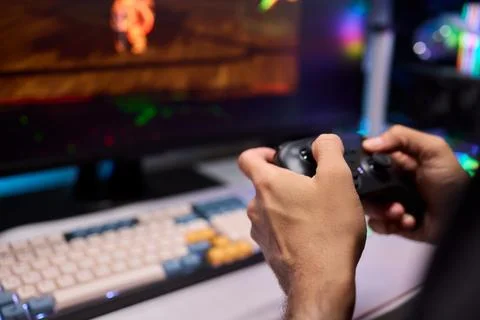Enjoying an exciting gaming session with a controller and large screen for Foto stock