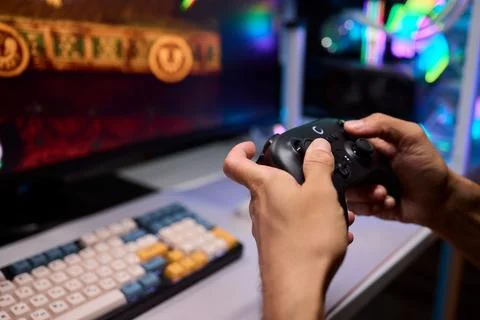 Enjoying an exciting gaming session with a controller and large screen for Foto stock