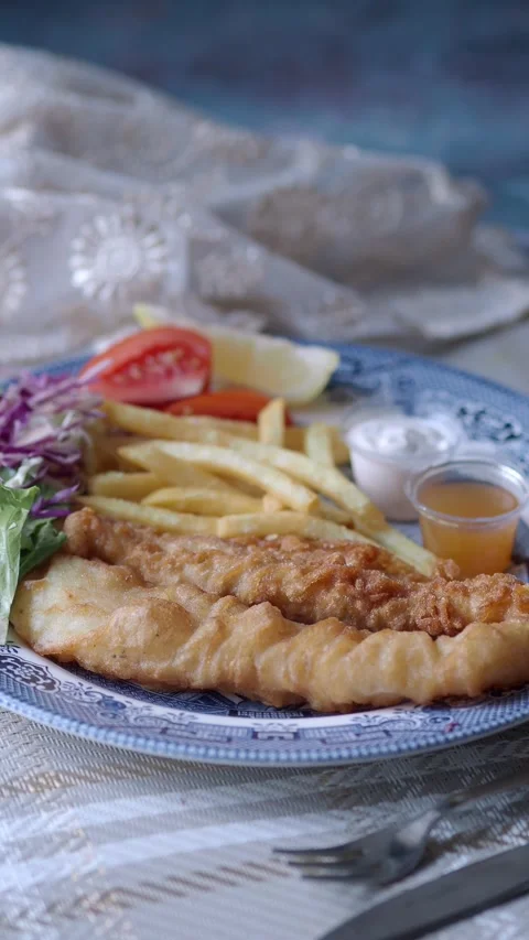 Enjoying fish and chips with sauce on a plate Stock Footage 337601215