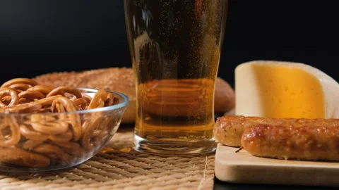 Enjoying fresh beer with snacks on a rustic table Stock Footage 317300156