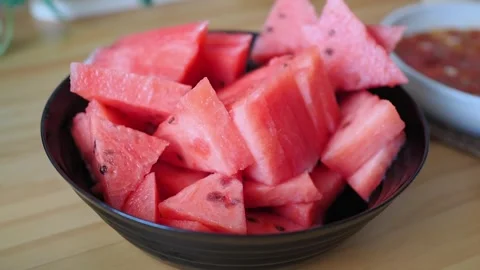 Enjoying fresh watermelon slices on a table with salsa Stock Footage 346269996