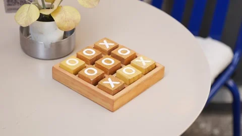 Enjoying a game of tic-tac-toe at a cafe table Stock Footage 334829227