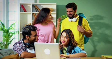Enjoying group study session, Indian students complete assignment using laptop Stock Footage 342383272