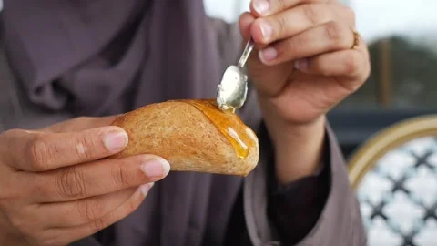 Enjoying honey on bread in a café Stock Footage 340303828
