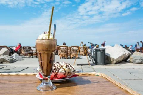 Enjoying ice coffee with banana split ice cream. Stock Photos