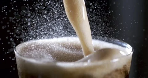 Enjoying the Mesmerizing Slow Motion of Coffee Pouring Into a Glass Stock Footage 336823757