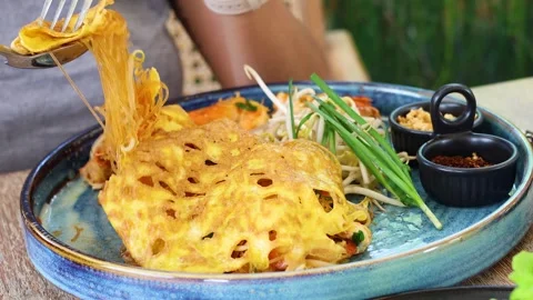 Enjoying a Plate of Pad Thai Stockbeeldmateriaal 284087374