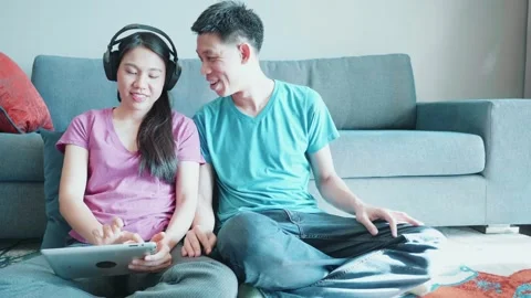 Enjoying Quality Time Together with Tablets and Headphones Stock Footage 314616359