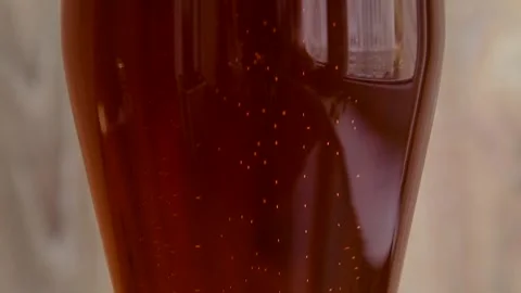 Enjoying a refreshing beer in a glass with bubbles and rich color Stock Footage 309112856