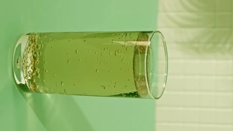 Enjoying a refreshing drink in a bright summer setting with bubbles Stock Footage 340462639