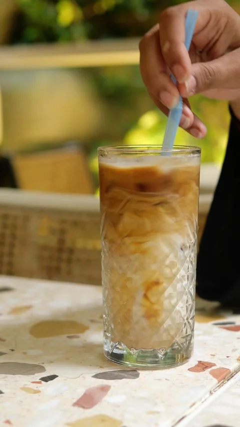 Enjoying a refreshing drink at a cafe in the afternoon Video stock 337981062