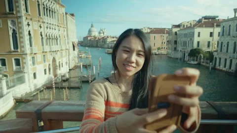 Enjoying a Scenic Moment While Taking a Selfie in Venice Stock Footage 314786702