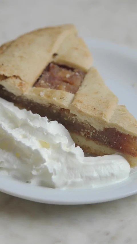 Enjoying a slice of apple pie with whipped cream Video stock 332749678