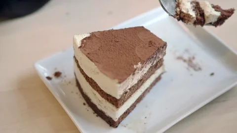 Enjoying a slice of cake at a cafe in the afternoon Stock Footage 336038497