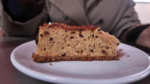 Enjoying a slice of cake at a local bakery Stock Footage 337445111