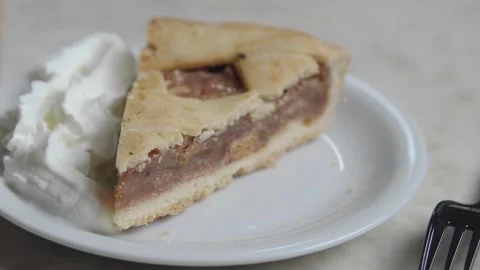 Enjoying a slice of pie with whipped cream on a plate Stock Footage 334907780