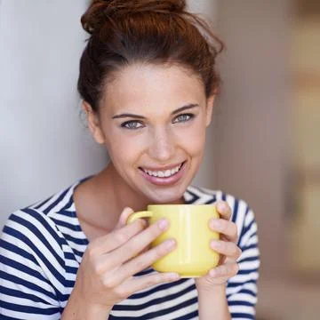 Enjoying some java. Portrait of an attractive young woman enjoying a cup of c Stock Photos