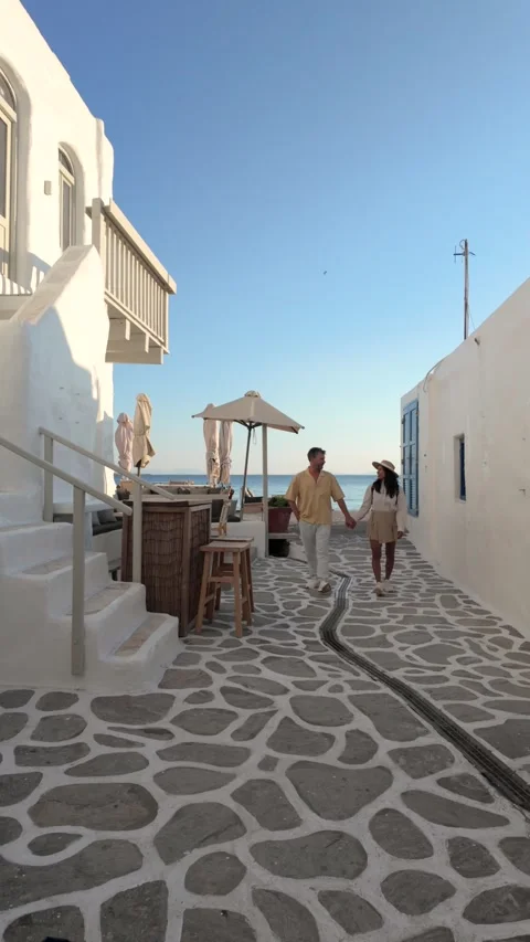 Enjoying a stroll in the charming streets of paros, greece during sunset Stock Footage 336529692