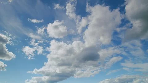 Enjoying the stunningly beautiful cloud patterns that adorn a clear, vibrant blu Stock Photos