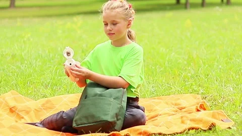 Enjoying a sunny day with a picnic in the park and a refreshing drink Stock-Footage 296332853