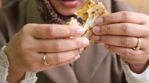 Enjoying a tasty meal while holding a flatbread sandwich Stock Footage 345188514