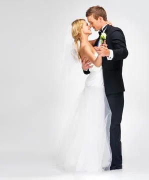 Enjoying their first dance. Portrait of a cute newlywed couple embracing. Stock Photos