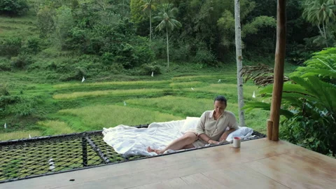 Enjoying tropical nature while resting with book Stock Footage 307080535