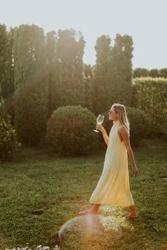 Enjoying a warm sunset while sipping a drink in a lush garden setting Stock Photos