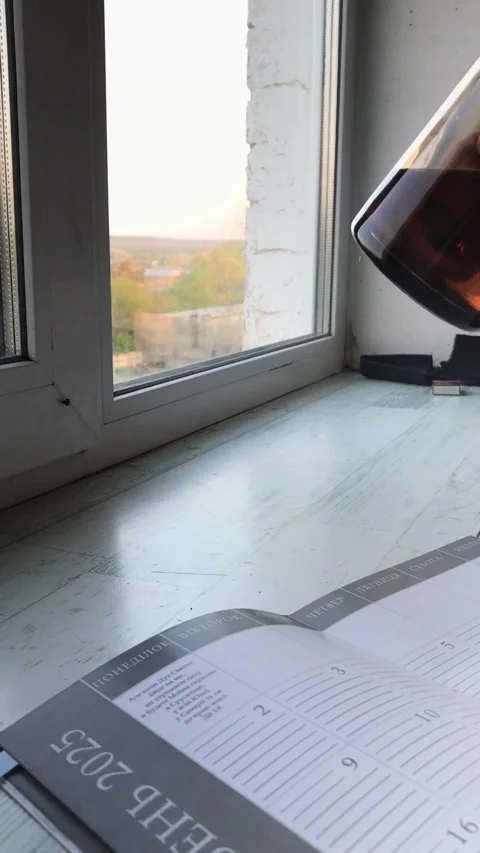 Enjoying warm tea by the window at sunset Stock Footage 308368072